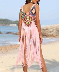 Detail of crochet boho beach cover-up with granny square back and long pink fringe