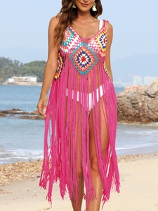 Detailed view of handmade multi-color crochet beach cover-up with long pink tassels