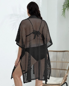 Detail of black crochet beach cover-up with wide mesh knit and side slit back view