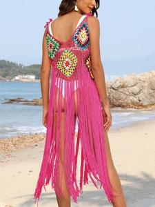 Detail of colorful bohemian handmade crochet beach cover-up with long magenta fringes