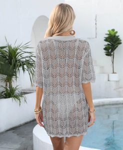 Back view of grey knit crochet beach cover-up featuring hollow-out leaf patterns