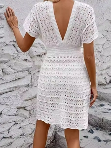 Deep V-neck white crochet beach dress with wave hollow out patterns and open back design