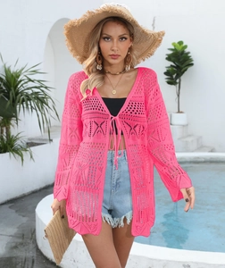 Detail of hot pink hollow crochet texture and lace-up front on beach cover up