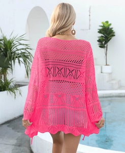 Detail of rose pink crochet beach cover-up with XIXIXI geometric knit pattern on back