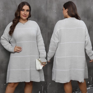 Close-up of thick knitted grey plus size dress with white large checkered pattern detail