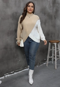 Detail of color-block knit sweater with asymmetrical beige and white paneling for women