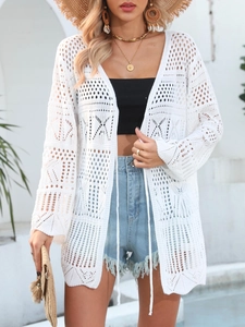 Detailed view of white hollow crochet knit cardigan with geometric pattern for beach cover-up