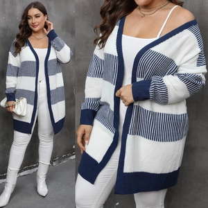 Close-up detail of blue and white striped knit texture on oversized open cardigan
