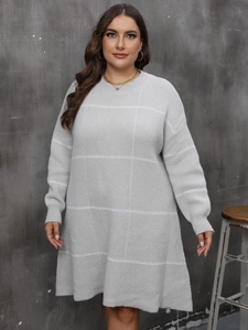 Close-up of soft light grey knitted dress with white grid patterns and round neckline