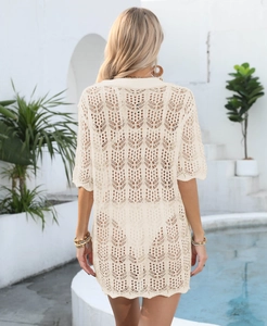 Detail view of beige crochet cover-up showing geometric floral hollow knit texture
