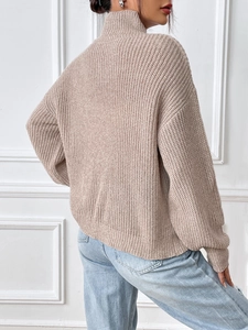 Women's turtle neck sweater in oatmeal beige knit with ribbed texture and loose fit