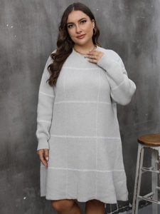 Detail of grey striped knit dress showing the soft textured fabric and crew neck design