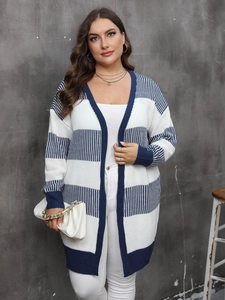 Detail of blue and white striped long knit cardigan with ribbed cuffs and golden chain bag