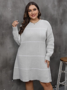 Women's plus size light grey knit dress featuring white grid pattern and long sleeves