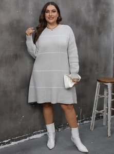 Detail of grey plus size knit dress featuring white grid pattern and textured fabric