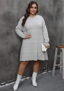Detail showing soft light grey knit texture with large white grid pattern for winter dress