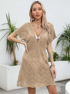 Detail of the crochet hollow design on this light brown deep V-neck beach dress