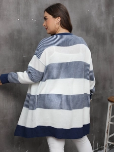 Detail view of long navy and white striped knit cardigan showing ribbed cuffs and texture