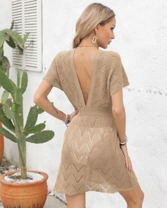 Detail of khaki crochet knit beach dress featuring a deep V back and wavy cutout texture