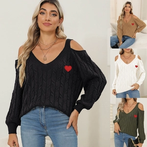 Detail showing the red heart embroidery on a V-neck cold shoulder knit sweater