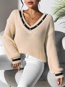 Women V-neck beige knit sweater with contrast black stripes and pearl buttons