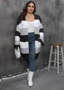 Long knit cardigan featuring black, grey, and white horizontal stripes with pockets