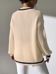Women's V-neck contrast knit sweater in cream white with black stripes from a back view