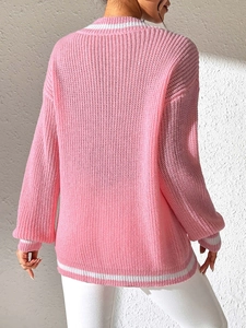 Detail view showing the back fit of a pink knit sweater with white striped ribbed trims