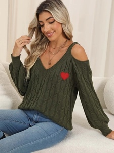 Detail of olive green cable knit sweater featuring cold shoulder V-neck and red heart patch