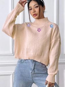 Chic high-neck knit sweater with colorful flower embroidery and a relaxed fit for women