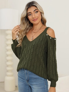Detail of olive green knit sweater featuring cut-out shoulders and white pearl accents
