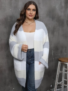 Close-up of fluffy striped cardigan featuring large pockets and fuzzy textured fabric