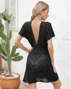 Detail showing backless deep V design and hollow knit pattern of the black beach dress