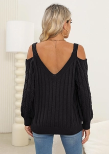 Detail of cable-knit texture on black cold-shoulder sweater with deep V-back