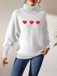 Detail of white turtleneck sweater with red heart embroidery and ribbed knit cuffs