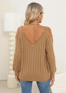 Detail of camel cable-knit sweater featuring deep V-back and cold-shoulder design