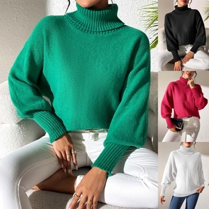 Detail of chunky knit turtleneck sweater featuring lantern sleeves and ribbed cuffs