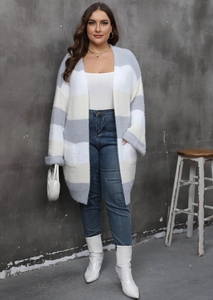 Detail of grey and yellow striped knitted cardigan showing soft texture and side pockets