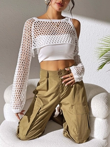 Detailed view of white crochet crop top texture paired with khaki utility cargo pants