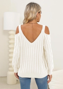 Detail of off-white knit sweater showing cold shoulder design and deep V-back cut