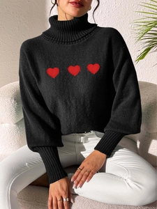 Close-up of black turtleneck knit sweater featuring three red embroidered hearts