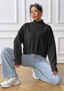 Chic black high-neck knit sweater paired with denim jeans and white sneakers outfit