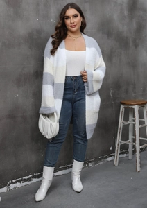 Detail of oversized striped knit cardigan featuring drop shoulder and plush texture