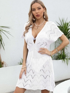 White crochet knit cover-up dress featuring a deep V-neck and scalloped hollow patterns