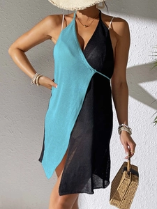 Detail of knit beach cover-up with contrast color block and asymmetrical hemline