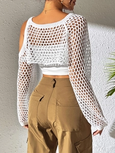 Detail of white crochet knit hollow-out crop top showing the back texture and long sleeves