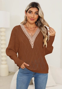 Detailed close-up of delicate lace crochet neckline and hollow knit on brown sweater
