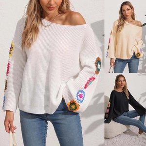 Detail of bohemian knit sweater with handmade floral crochet sleeves in three colors