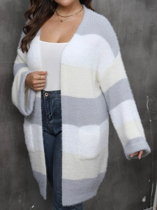 Close-up of plush striped cardigan with grey and beige panels and functional side pockets
