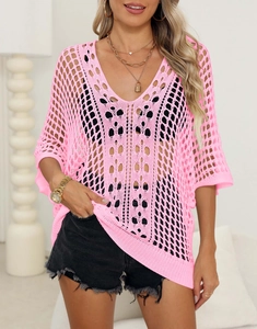 Close-up of bright pink hollow-out knit bikini cover-up with stylish crochet mesh texture